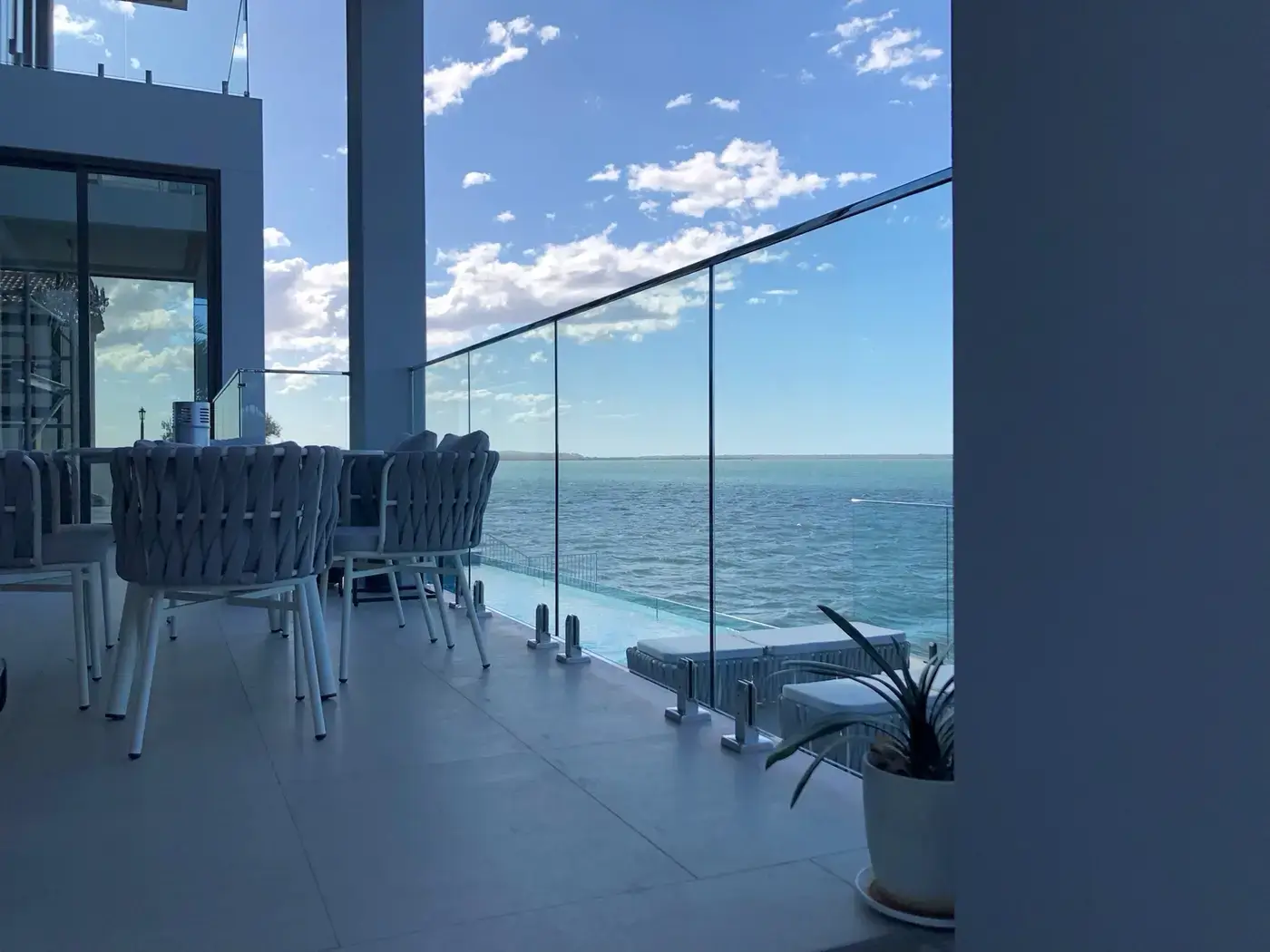 Coastal apartment glass balustrade overlooking the ocean