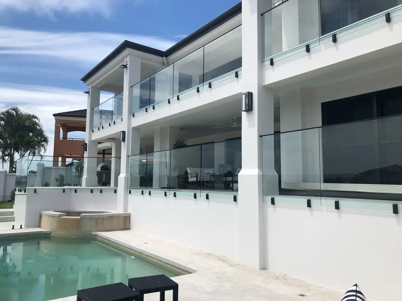 Multi-storey property with glass balcony balustrades