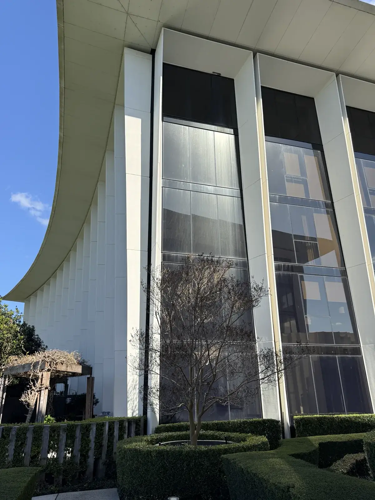 High residential façade windows with extensive water staining before restoration