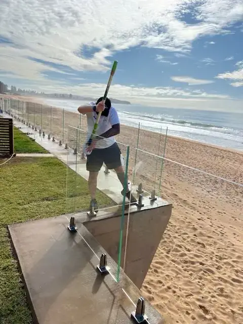 Glass Armour technician preparing beachfront glass fencing