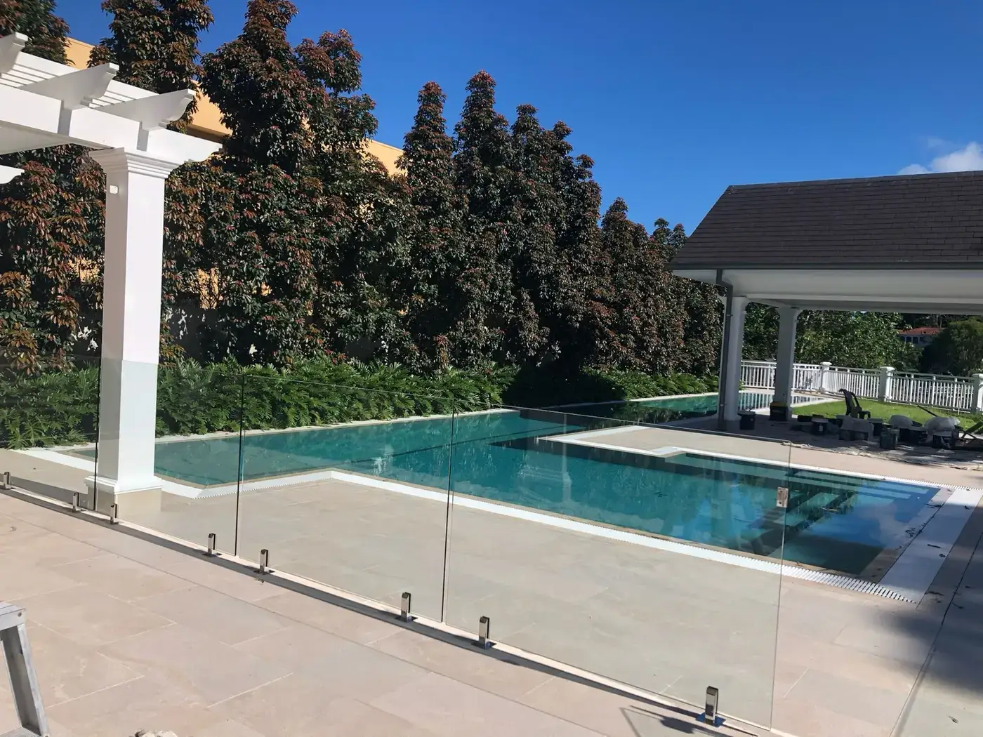Resort-style pool with protected frameless glass fencing