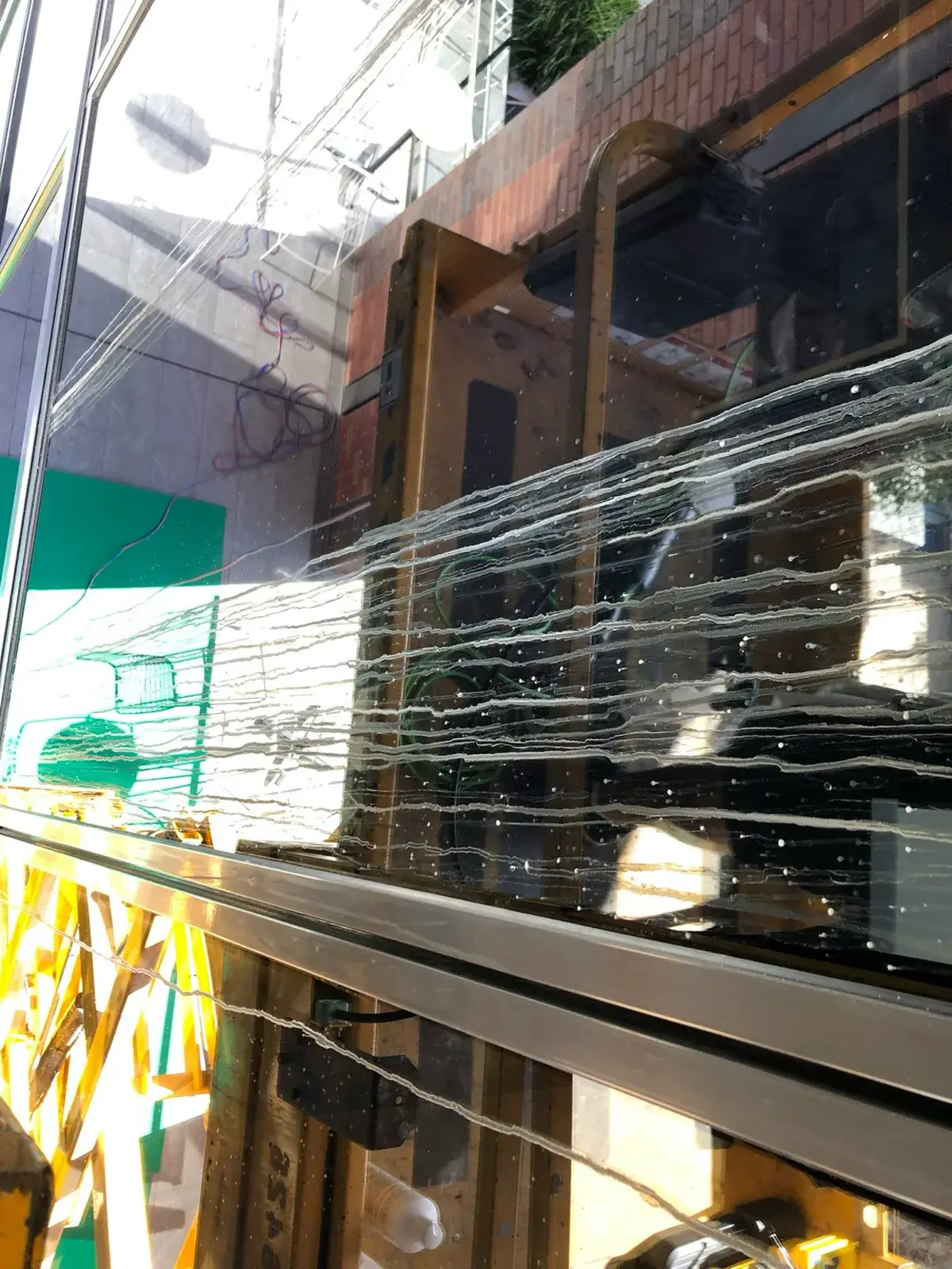 Bonded contamination across commercial fa&ccedil;ade glass before restoration